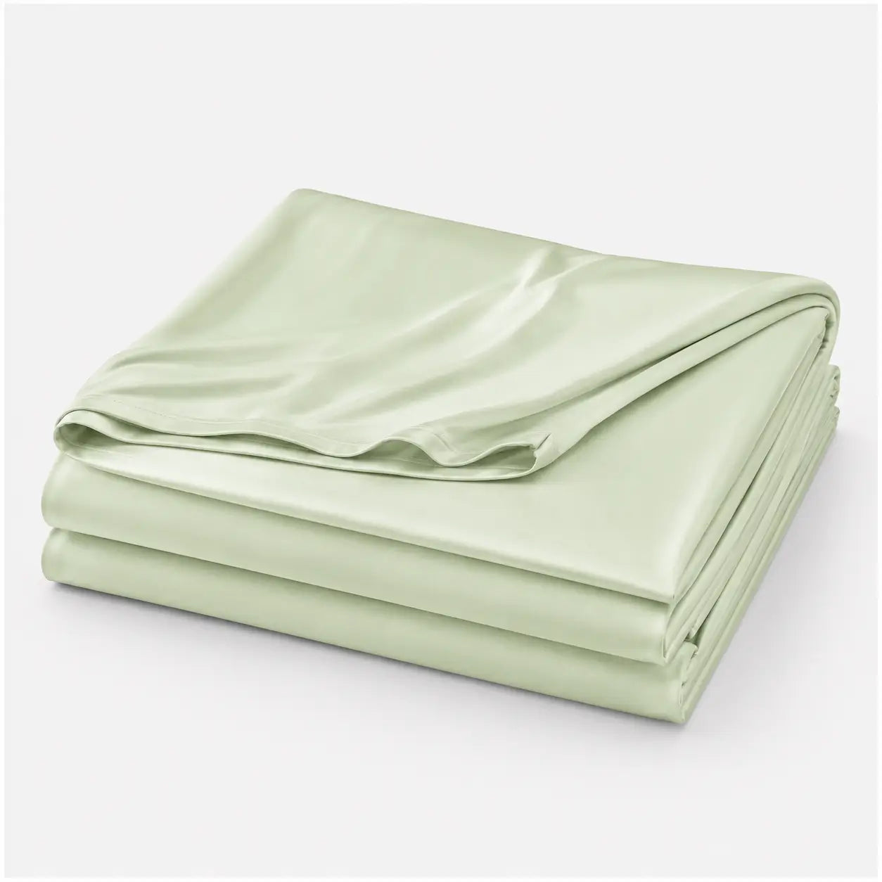 Couverture rafraîchissante Marea vert sauge, légère et respirante, en tissu effet soie glacée, présentée pliée sur fond blanc.